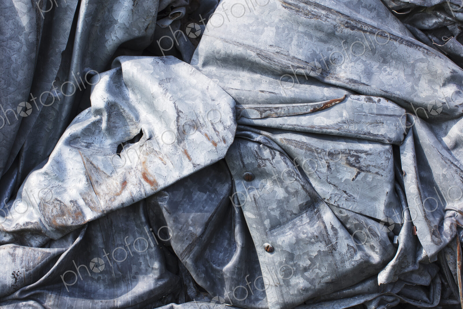 Close up of a pile of dented, crumpled and rusty metal.