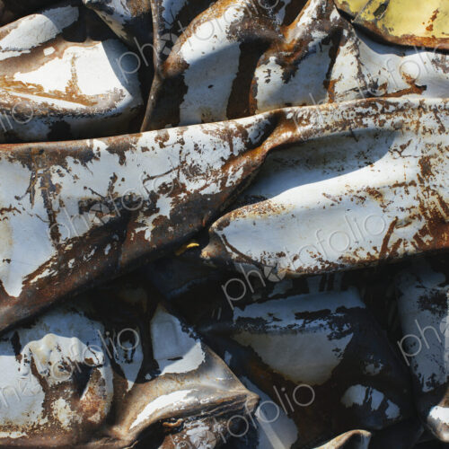 Close up of a pile of dented, crumpled and rusty metal.