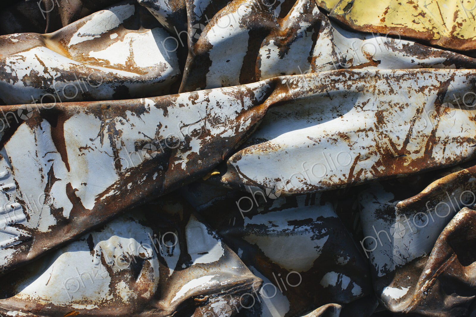 Close up of a pile of dented, crumpled and rusty metal.