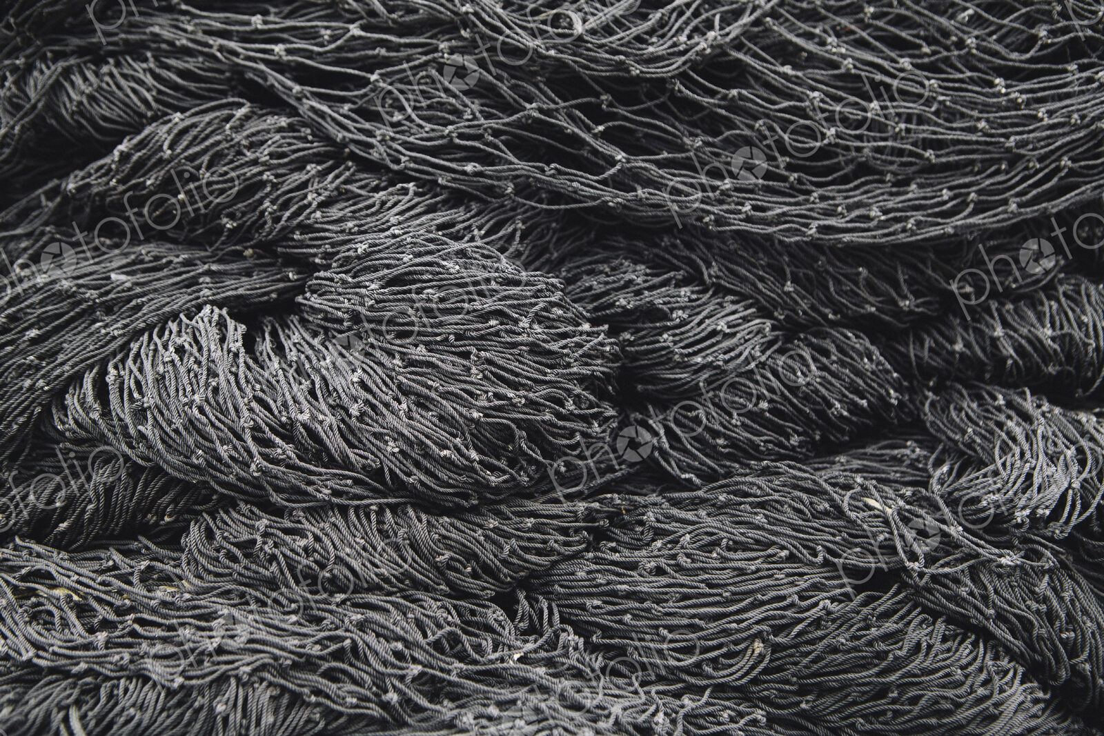 Close up of a pile of tangled up commercial fishing nets.