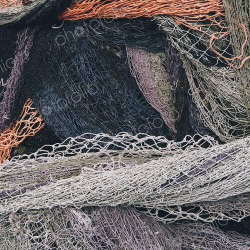 Close up of a pile of tangled up commercial fishing nets. Close up of a pile of tangled up commercial fishing nets.