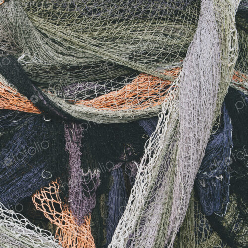 Close up of a pile of tangled up commercial fishing nets. Close up of a pile of tangled up commercial fishing nets.