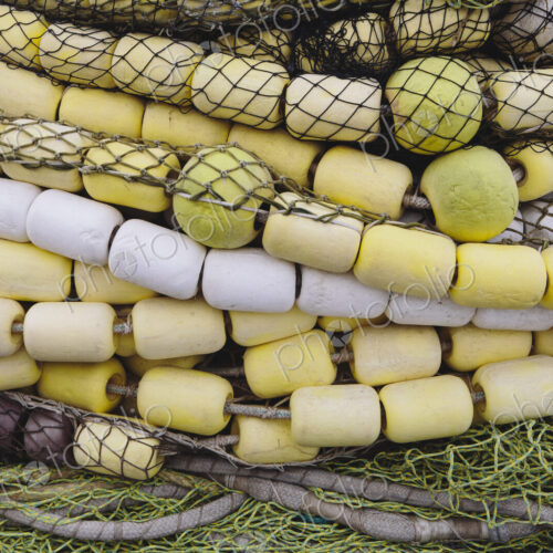 Close up of a pile of tangled up commercial fishing nets with floats attached. Close up of a pile of tangled up commercial fishing nets with floats attached.