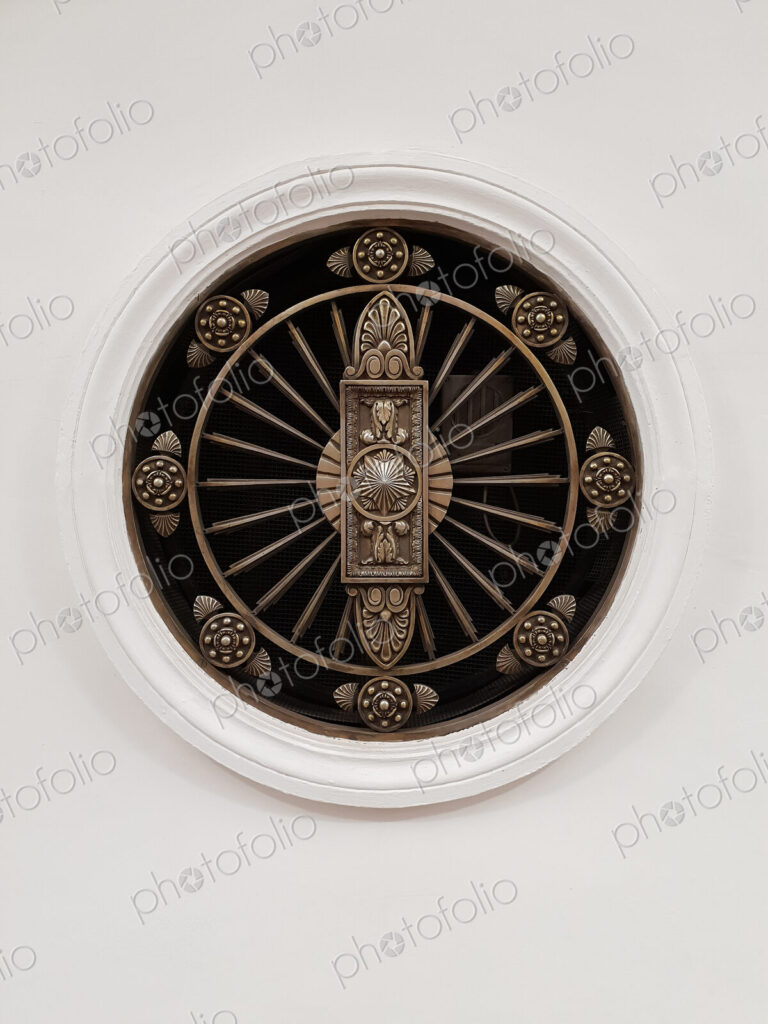 Close up of a roundel with designs.