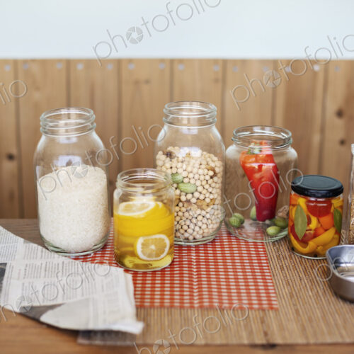 Close up of a selection of foods and condiments in glass jars in a farm shop. Close up of a selection of foods and condiments in glass jars in a farm shop.