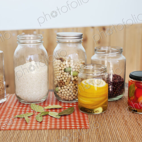 Close up of a selection of foods and condiments in glass jars in a farm shop. Close up of a selection of foods and condiments in glass jars in a farm shop.