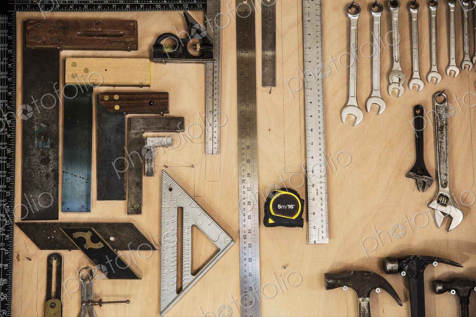 Close up of a selection of tools on a wall in a woodworking workshop.