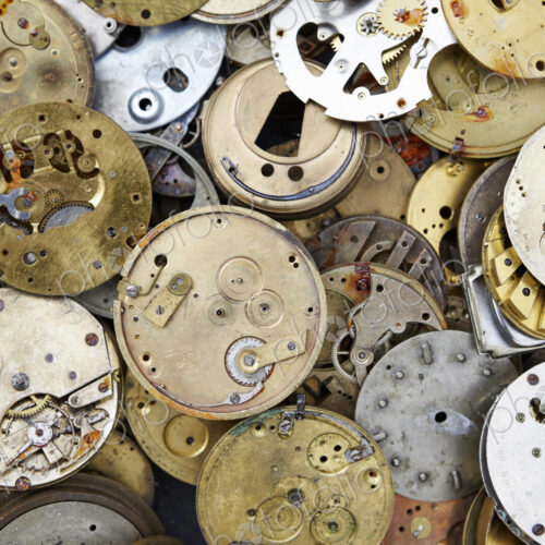 Close up of a selection of vintage clockworks at a flea market.