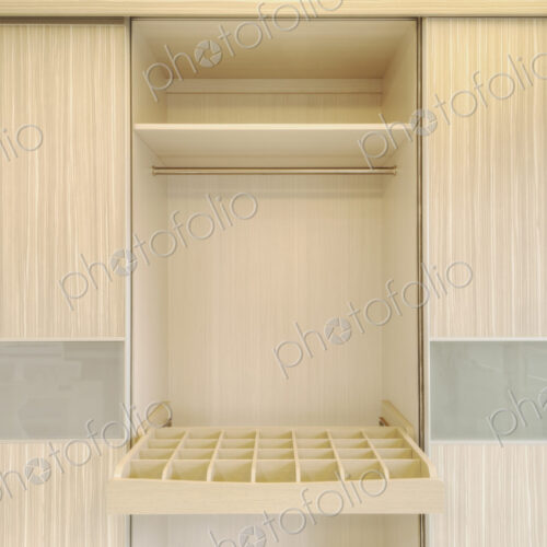 Close up of a simple wooden wardrobe with sock or tie drawer.