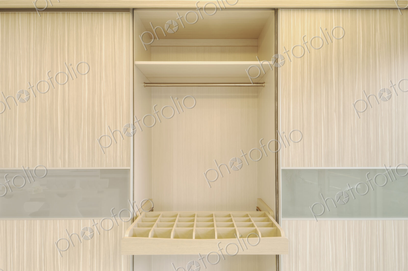 Close up of a simple wooden wardrobe with sock or tie drawer.
