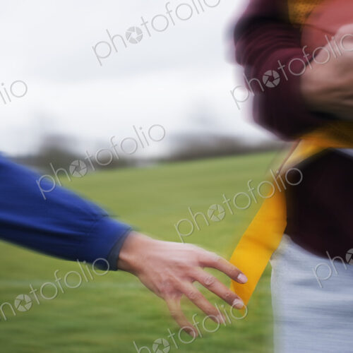 Close up of a sports player reaching for a flag to score a point in non-contact flag… Close up of a sports player reaching for a flag to score a point in non-contact flag…