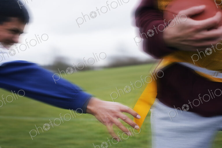 Close up of a sports player reaching for a flag to score a point in non-contact flag…