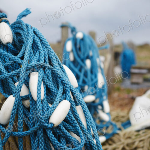 Close up of a tangle of blue fisherman's rope with white floats.