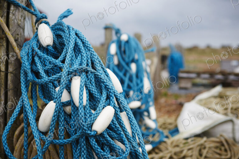 Close up of a tangle of blue fisherman's rope with white floats.