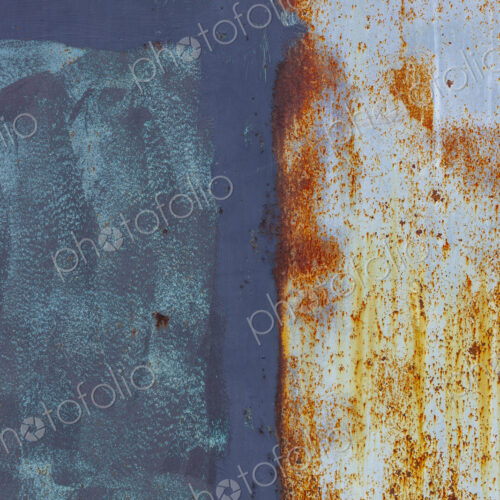 Close up of a wall, with rust and paint marks, vandalism and decay.