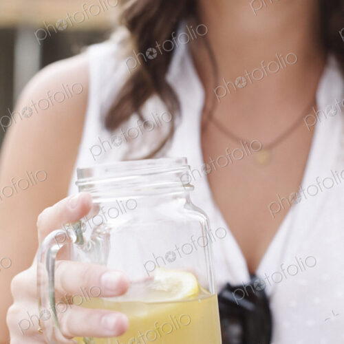 Close up of a woman holding a drink. Close up of a woman holding a drink.