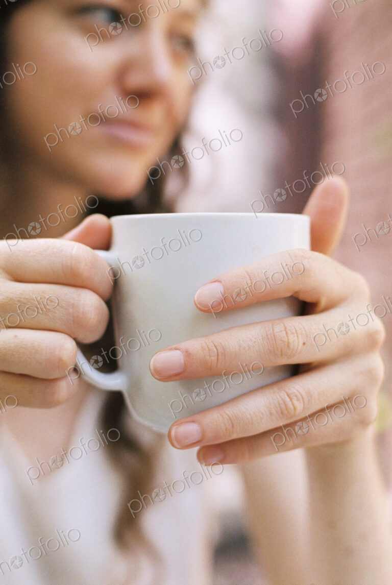 Close up of a woman holding a teacup.