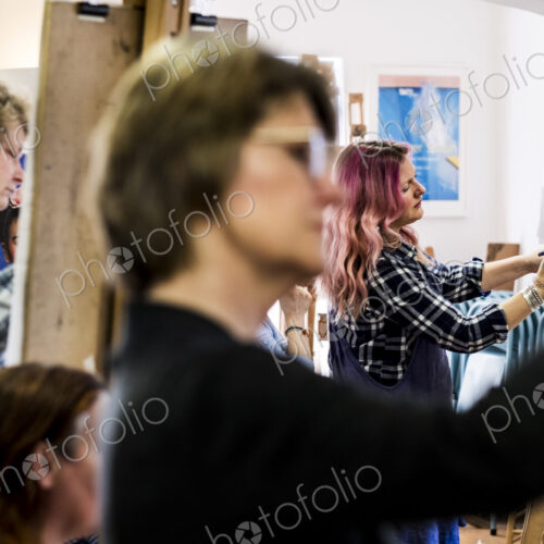 Close up of a woman standing at an easel, drawing. Close up of a woman standing at an easel, drawing.