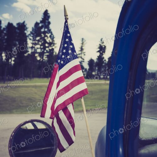 Close-up of an American flag mounted on an antique truck in Hill City, South Dakota,… Close-up of an American flag mounted on an antique truck in Hill City, South Dakota,…