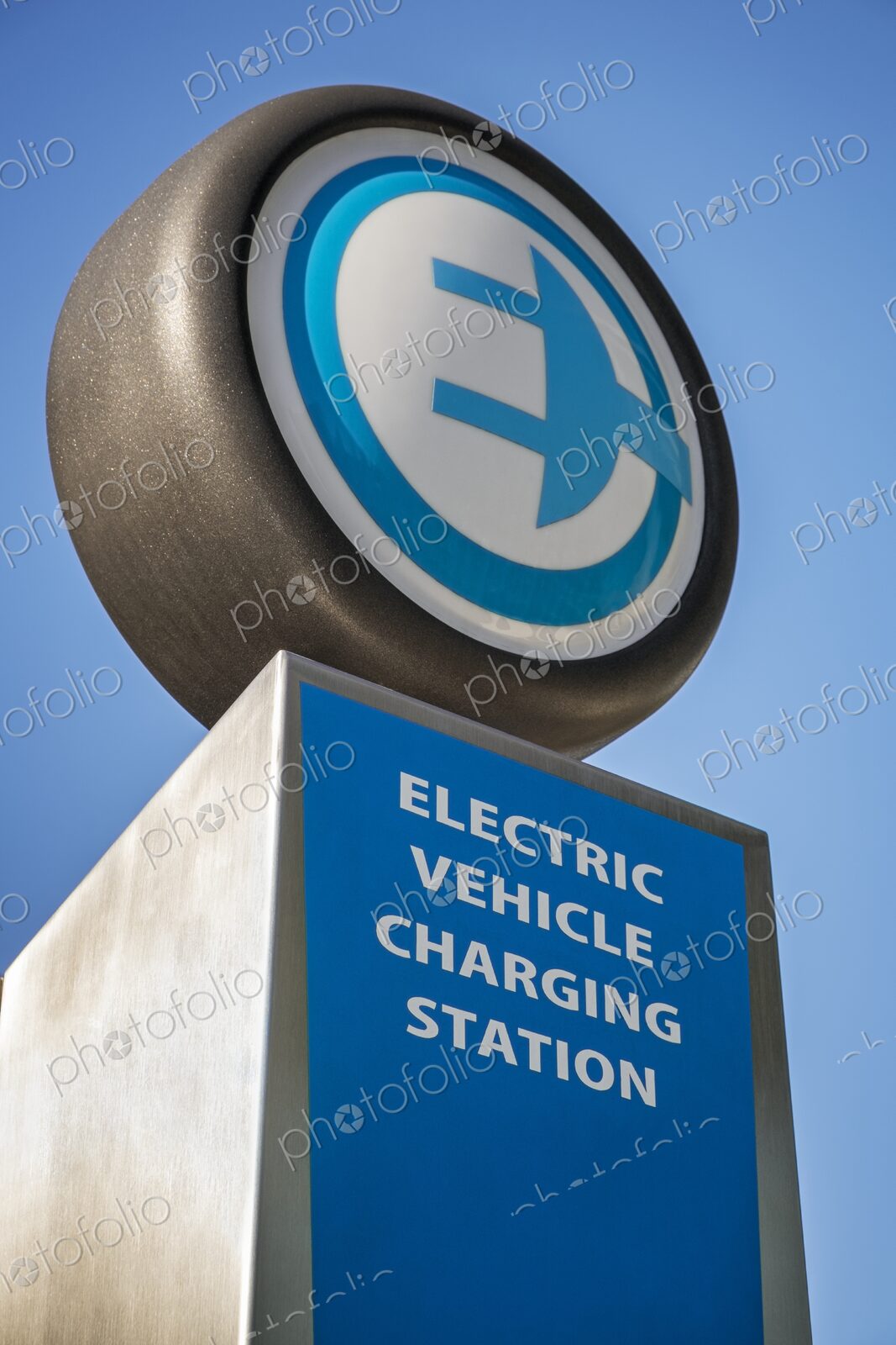 Close-up of an electric vehicle charging station sign with plug icon, photographed…