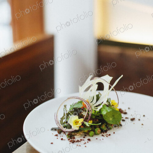 Close up of an elegantly presented plate of food at a city restaurant.