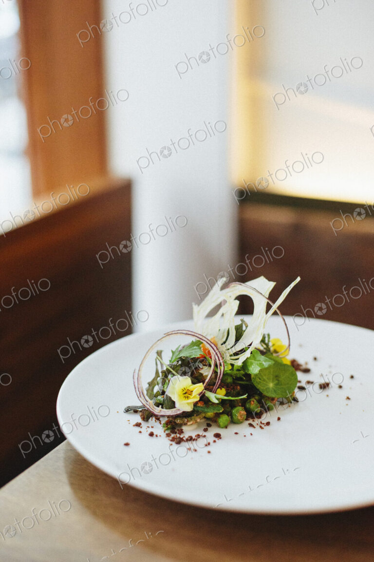 Close up of an elegantly presented plate of food at a city restaurant.
