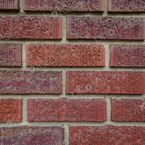 Close-up of an old clay red brick wall, laid in a running bond pattern with mortar. Close-up of an old clay red brick wall, laid in a running bond pattern with mortar.
