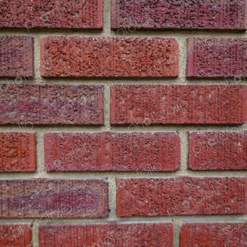 Close-up of an old clay red brick wall, laid in a running bond pattern with mortar. Close-up of an old clay red brick wall, laid in a running bond pattern with mortar.