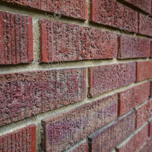 Close-up of an old clay red brick wall, laid in a running bond pattern with mortar. Close-up of an old clay red brick wall, laid in a running bond pattern with mortar.