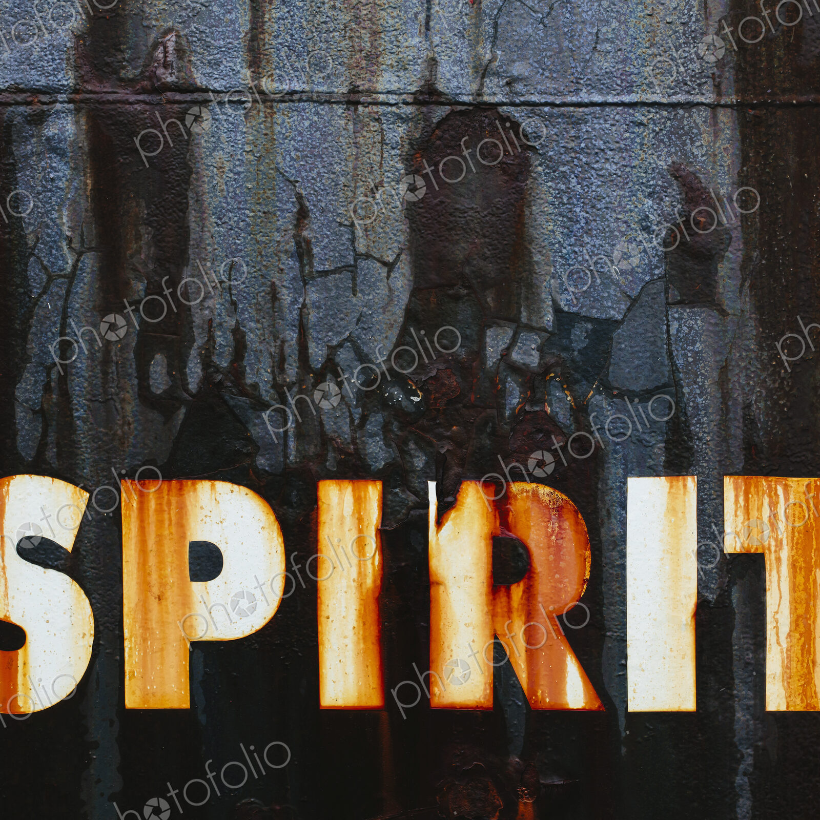 Close up of an old, rusty, commercial fishing boat. The word Spirit painted on the hull.