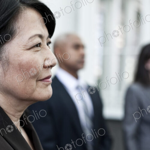 Close-up of asian business woman in a group of people. Close-up of asian business woman in a group of people.