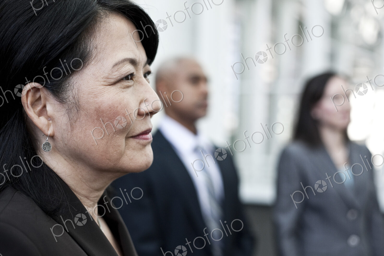 Close-up of asian business woman in a group of people.