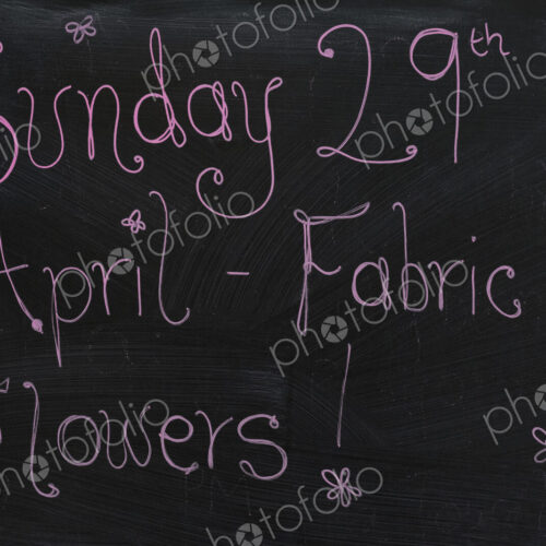 Close up of blackboard with handwriting advertising fabric flower workshop. Close up of blackboard with handwriting advertising fabric flower workshop.