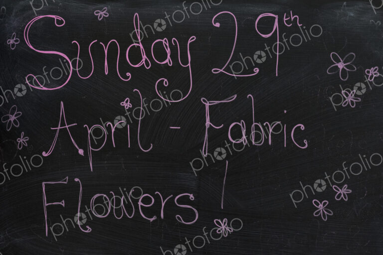 Close up of blackboard with handwriting advertising fabric flower workshop.