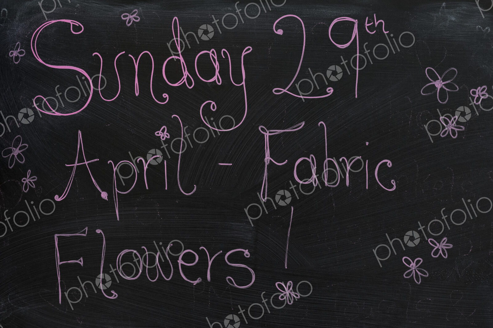 Close up of blackboard with handwriting advertising fabric flower workshop.