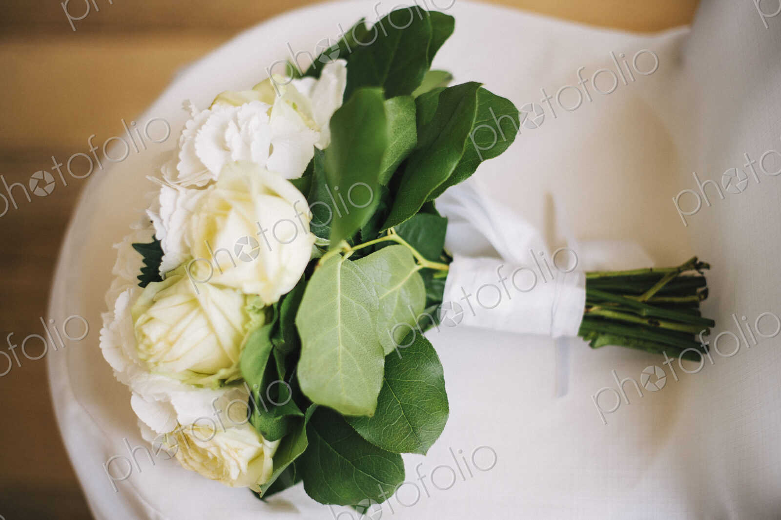 Close up of bouquet of flowers on wedding dress