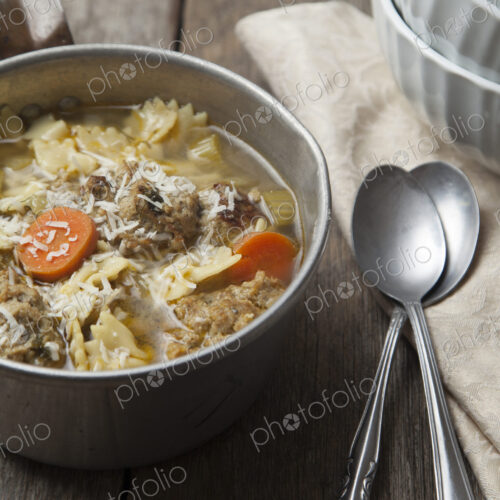 Close up of bowl of soup with spoons Close up of bowl of soup with spoons