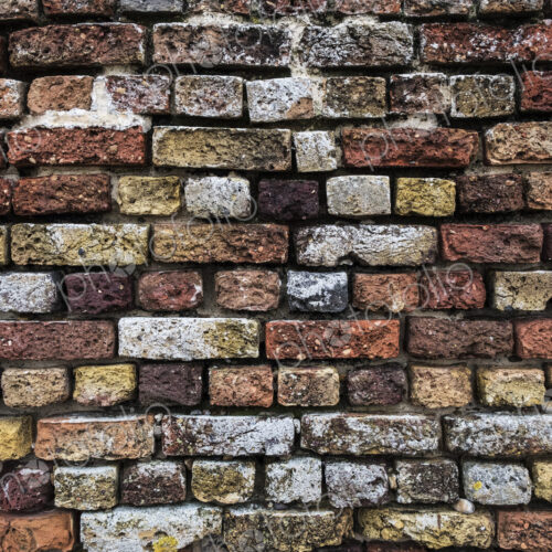Close up of brick wall with bricks in a variety of colours and textures. Close up of brick wall with bricks in a variety of colours and textures.