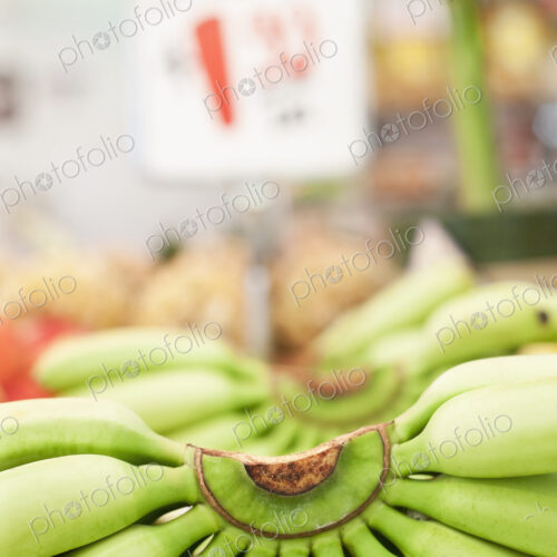 Close-up of bunch of bananas on market stall.