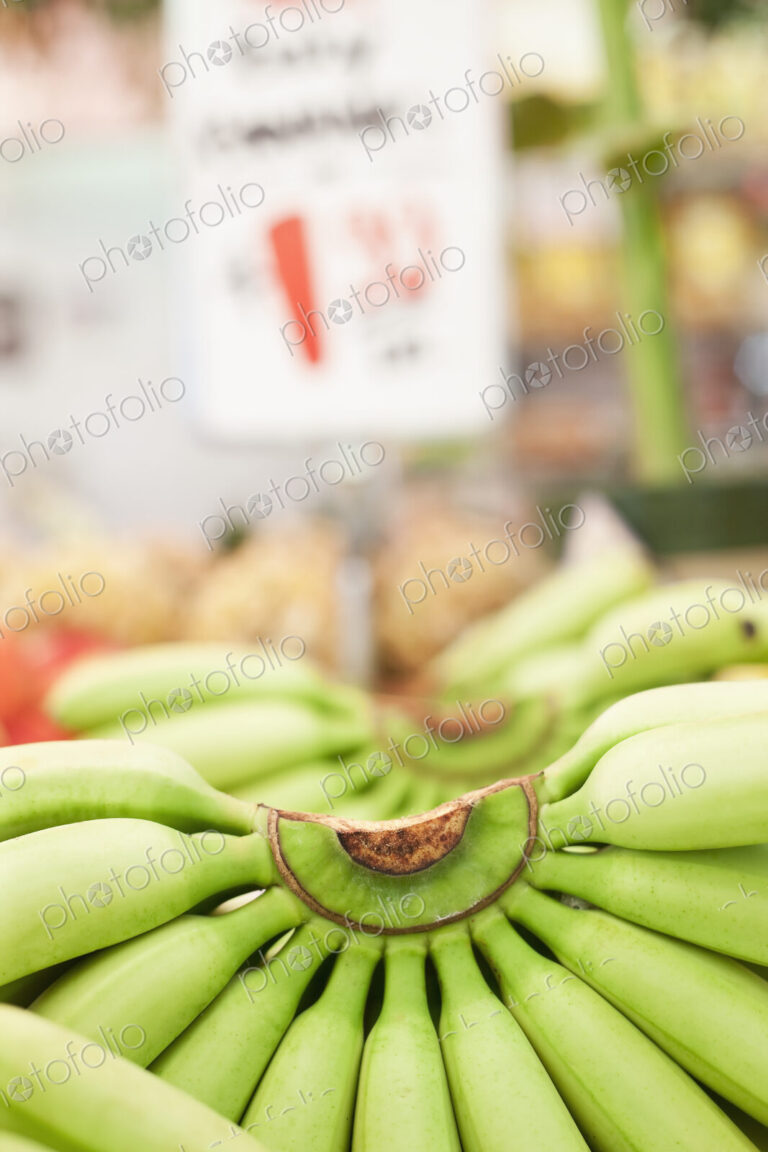 Close-up of bunch of bananas on market stall.