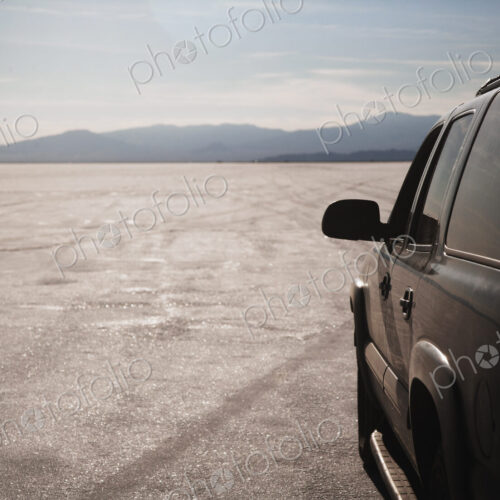 Close up of car driving on salt flats, Bonnaville Salt Flats, Utah, United States