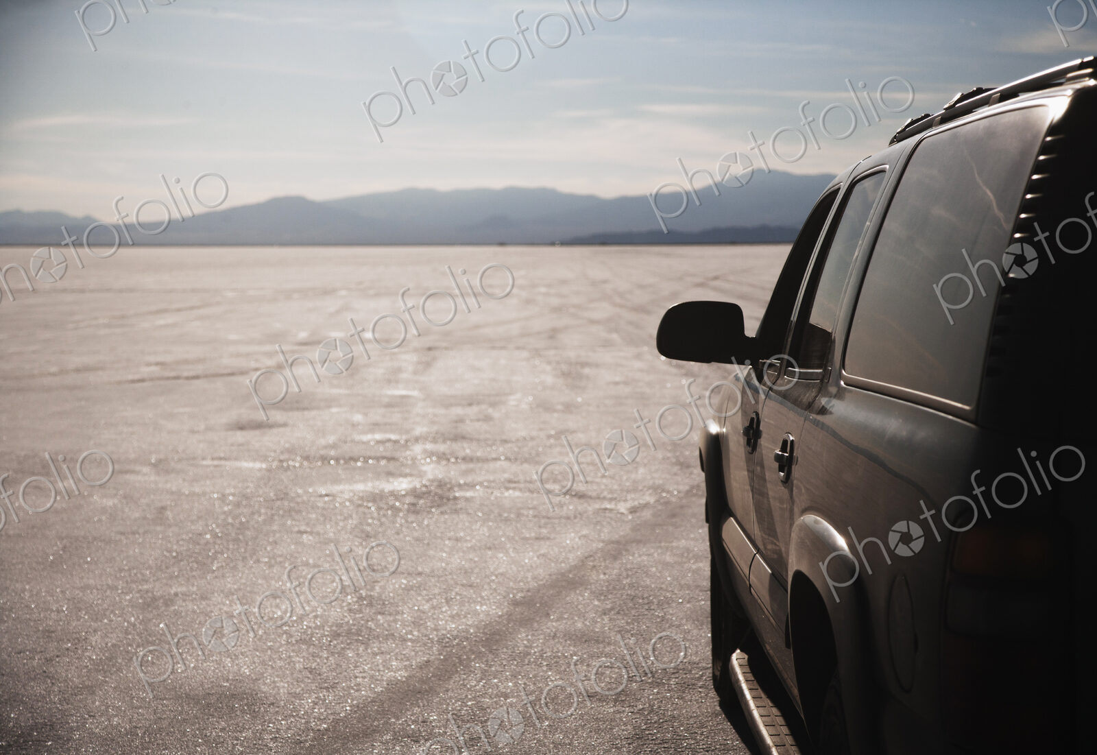 Close up of car driving on salt flats, Bonnaville Salt Flats, Utah, United States