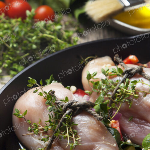 Close up of chicken breast wrapped with herbs
