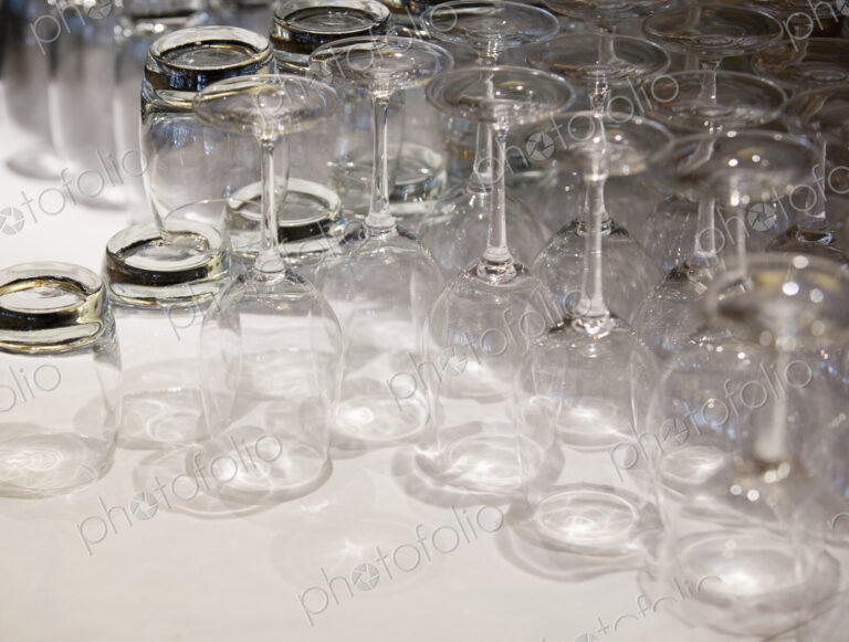 Close up of clean drinking glasses on a white surface