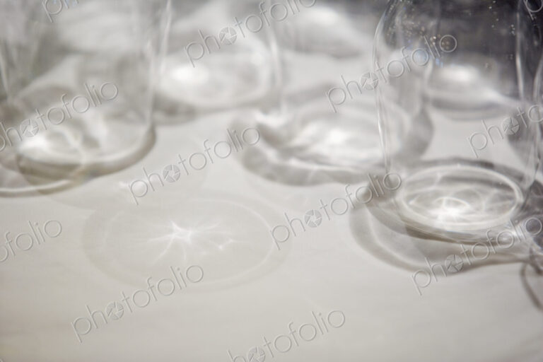 Close up of clean drinking glasses on a white surface