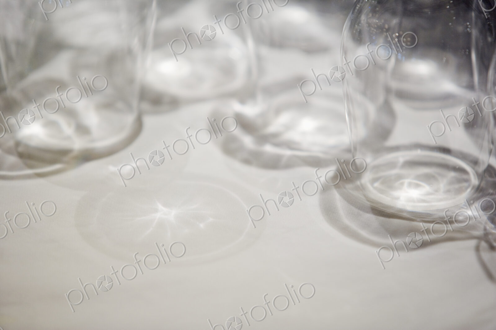 Close up of clean drinking glasses on a white surface