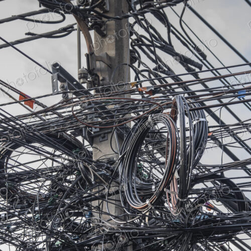 Close up of coiled power lines on pole