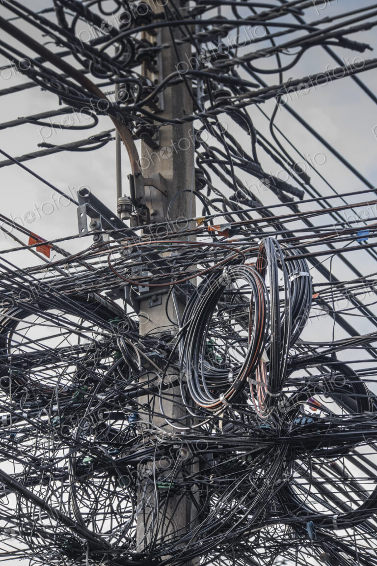 Close up of coiled power lines on pole