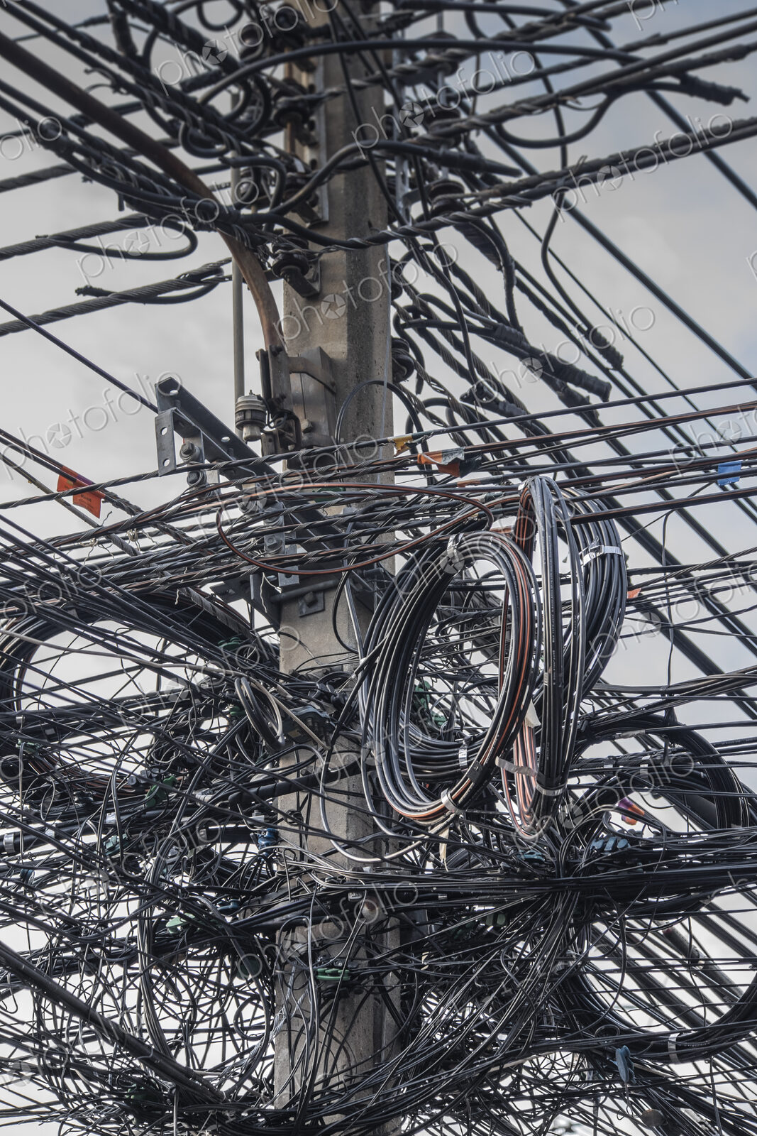 Close up of coiled power lines on pole