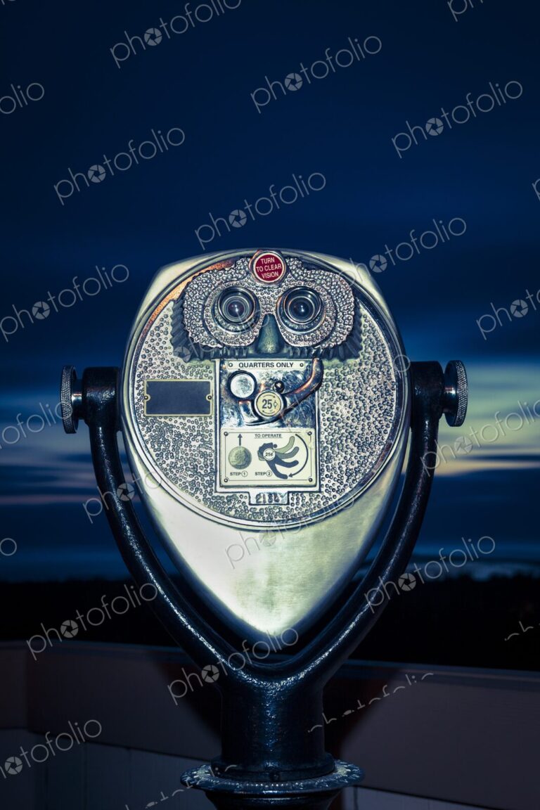 Close-up of coin-operated binoculars at dusk, overlooking Winchester Bay, Oregon.
